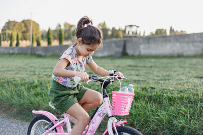 Boy riding bicycle on field