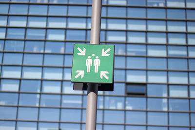 Low angle view of information sign against the sky