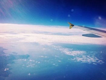 Cropped image of airplane flying over landscape