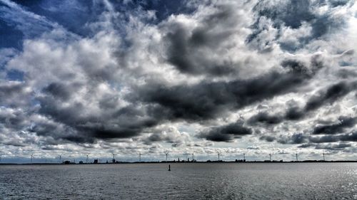 Scenic view of sea against storm clouds