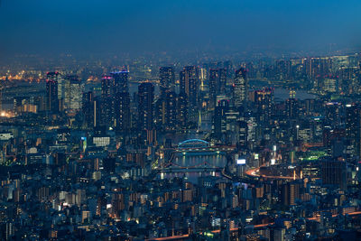 Aerial view of illuminated buildings in city at night