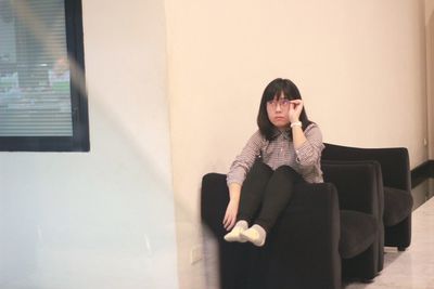 Young woman using phone at home