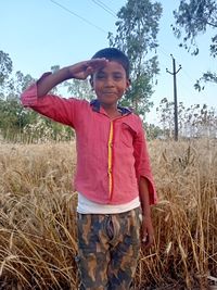 Full length of boy standing on field