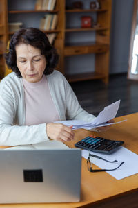 Young woman using laptop at table