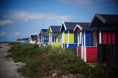 Houses on beach against sky