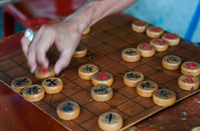 High angle view of hands playing on table