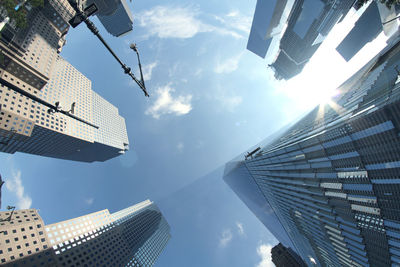 Directly below shot of modern buildings against sky in city