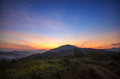 Scenic view of mountains against sky at sunset