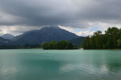 Scenic view of lake and mountains against sky