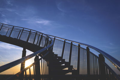 Low angle view of footbridge against sky