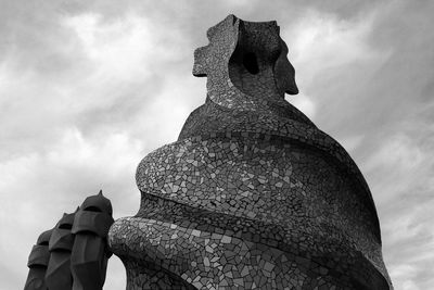 Low angle view of statue against cloudy sky