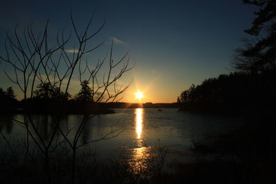 Scenic view of lake at sunset