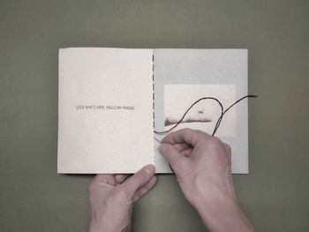 Cropped hand holding book