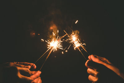 Low angle view of firework display at night