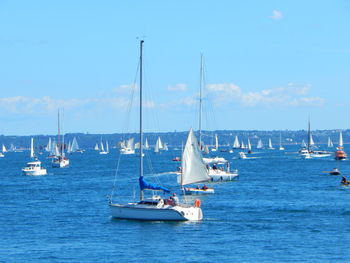 Boats sailing in sea against sky