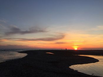 Scenic view of beach against sky during sunset