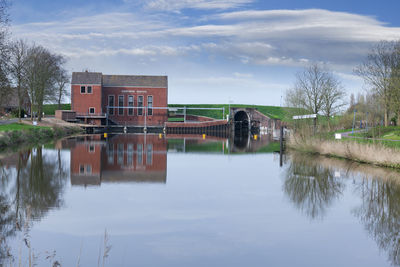 View over the inland waterway binnenmude on the old pumping station in greetsiel.