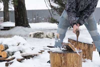 Low section of man holding snow