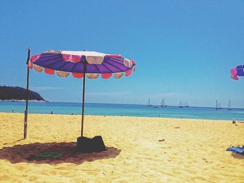 Scenic view of beach against blue sky