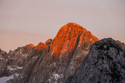 Scenic view of rock formations against clear sky during sunset
