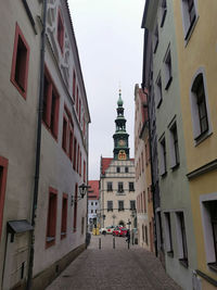 Street amidst buildings against sky in city