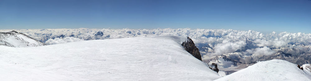 Snow covered landscape against sky