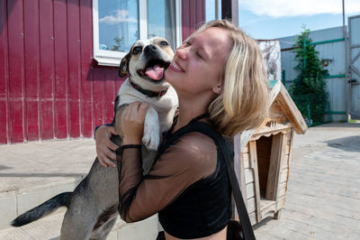 Low section of woman with dog
