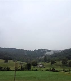 Scenic view of farm against sky