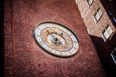 Low angle view of clock on building wall