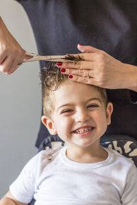 Portrait of boy having haircut