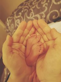 Close-up of hand holding baby