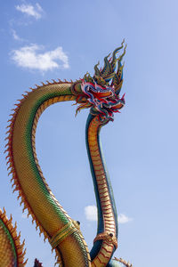 Low angle view of carousel against sky