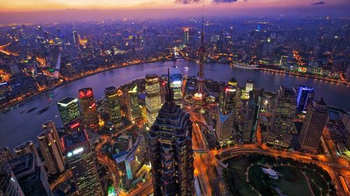 High angle view of city lit up at night