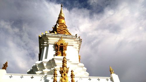 Low angle view of statue of temple against cloudy sky