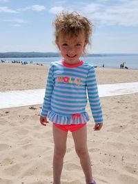 Portrait of smiling girl standing at beach