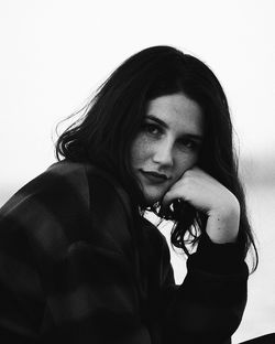 Portrait of young woman sitting outdoors