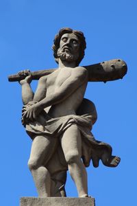 Low angle view of statue against clear blue sky