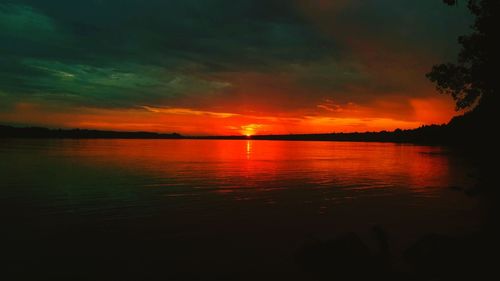 Scenic view of lake against romantic sky at sunset