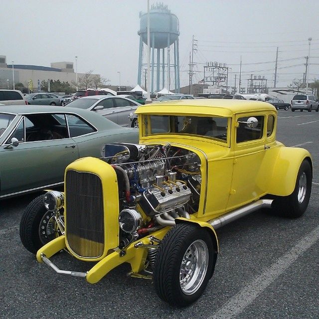 transportation, mode of transport, land vehicle, car, yellow, street, stationary, parking, parked, travel, road, vehicle, parking lot, outdoors, bus, city, motorcycle, day, vintage car, headlight