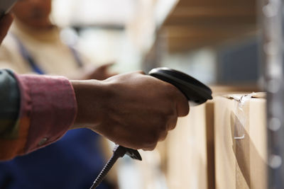 Cropped hand of man repairing car