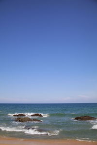 Scenic view of sea against clear blue sky