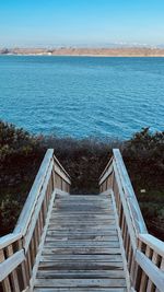 Empty beach by sea against sky