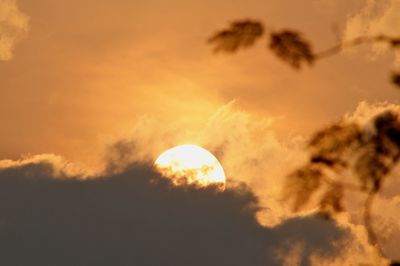 Low angle view of silhouette moon against sky at sunset