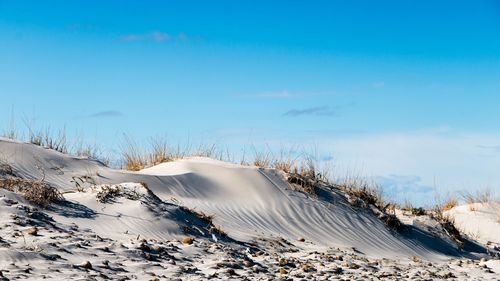 Snow covered land against sky