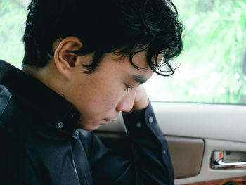 Close-up of young man looking away