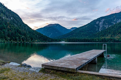 Scenic view of lake by mountains against sky