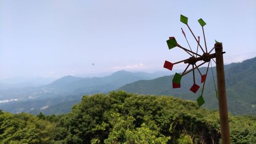 Low angle view of flags on mountain against sky