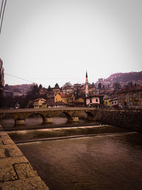 View of bridge over river in city