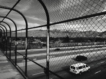 Chainlink fence with railing in background