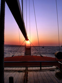 Boat sailing in sea during sunset